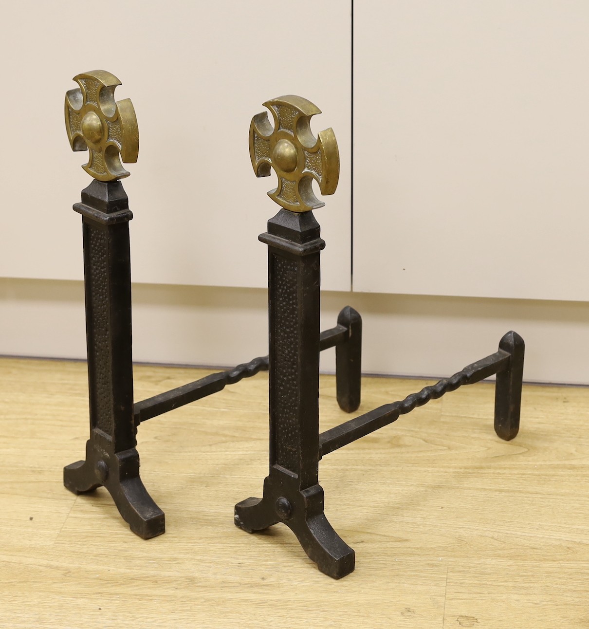 A pair of Victorian cast iron and brass fire dogs, 54cm tall